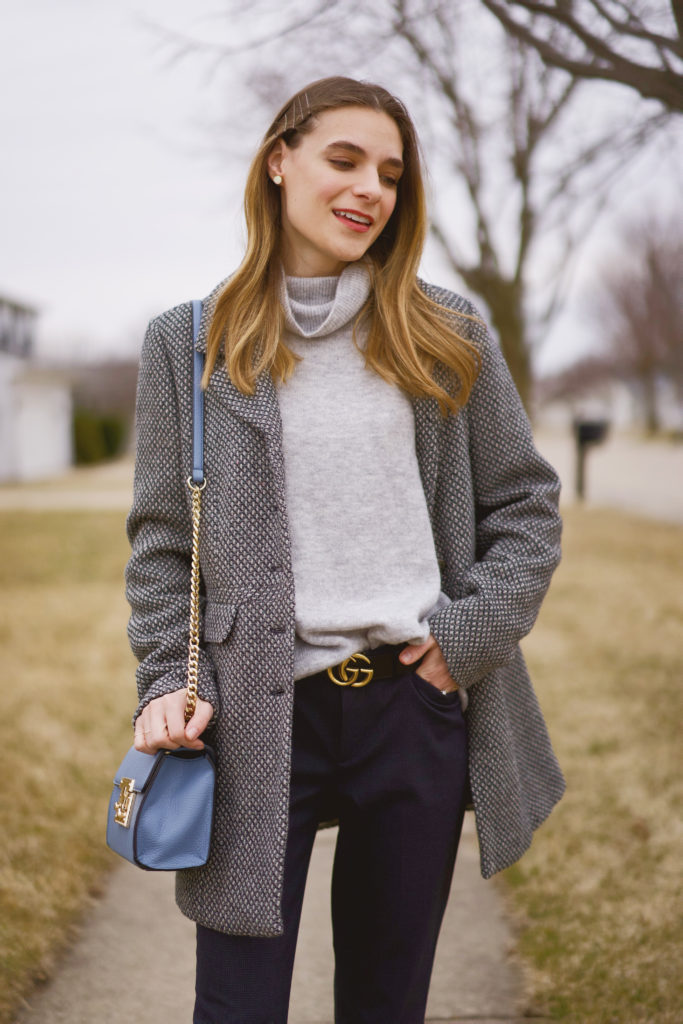 Women's oversized gray turtleneck sweater by H&M worn with an oversized check print coat