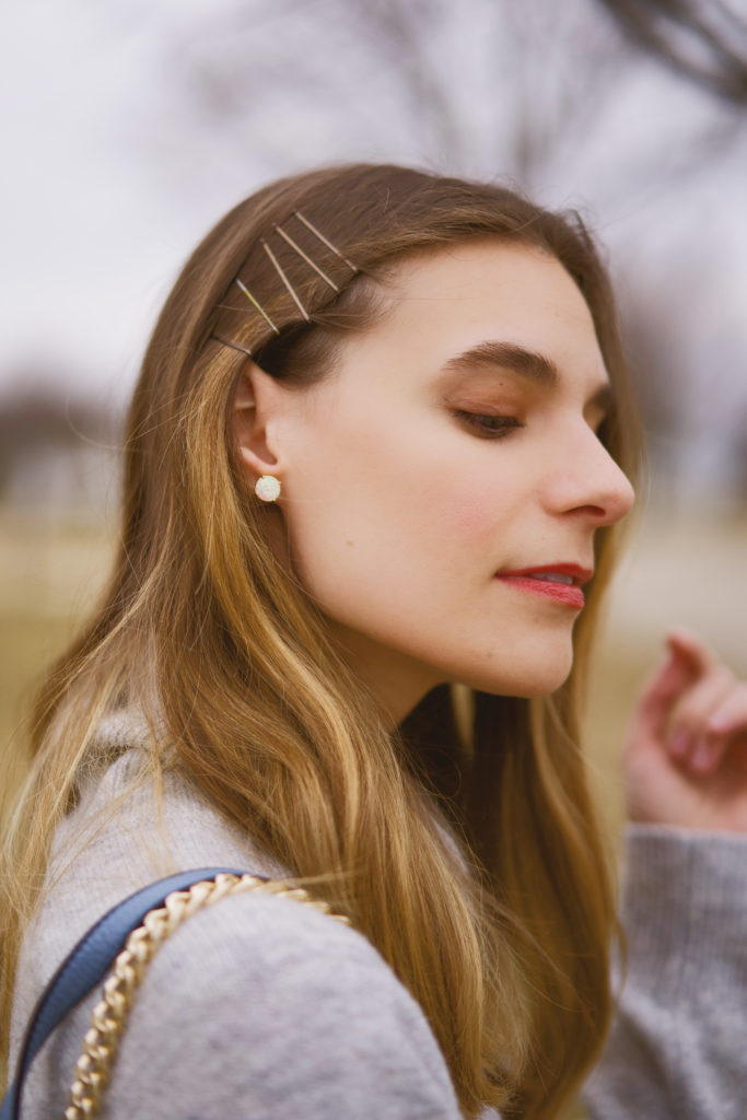 Girl wearing several bobby pins in her hair on the right side of her head