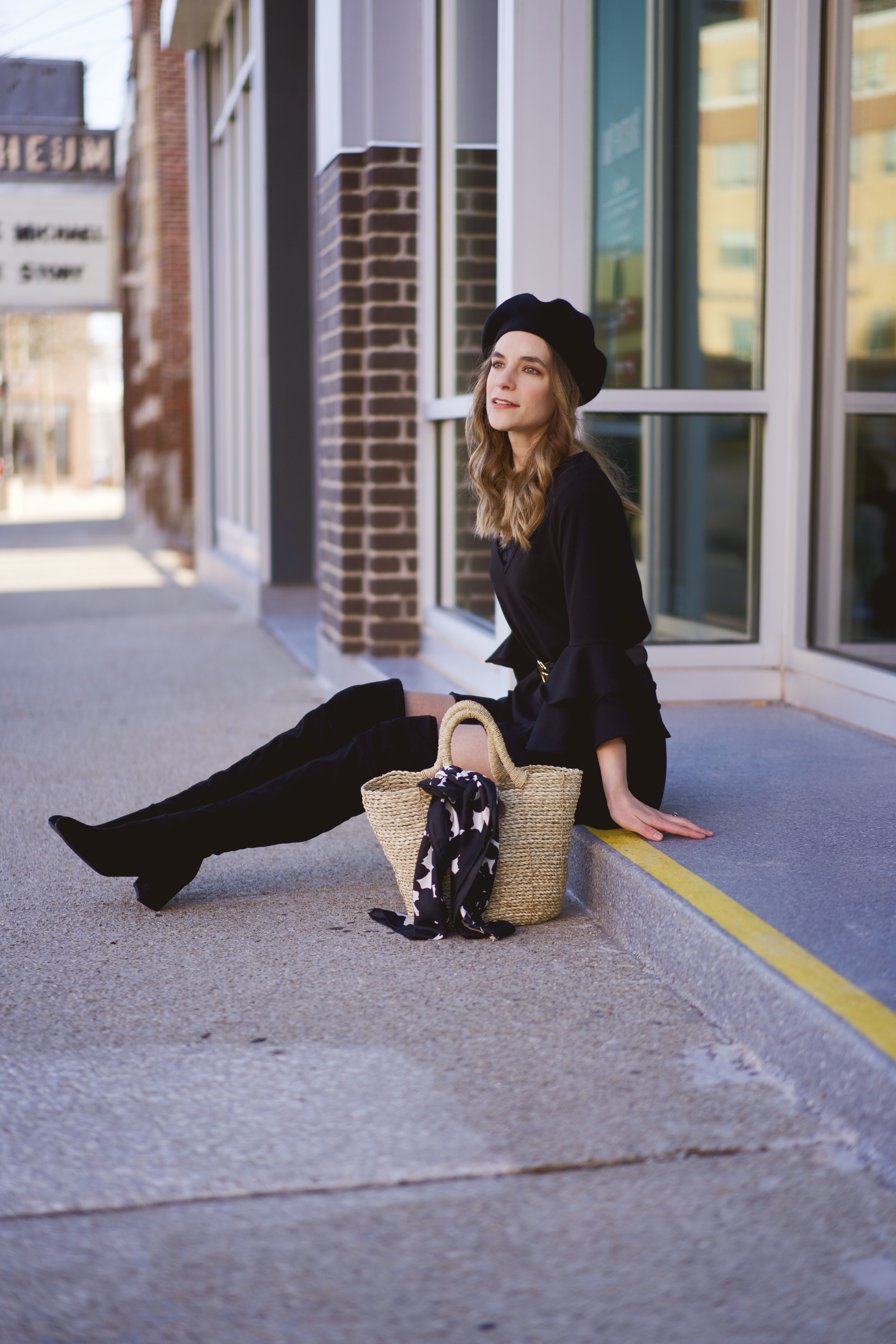 A black dress, boots, and beret 