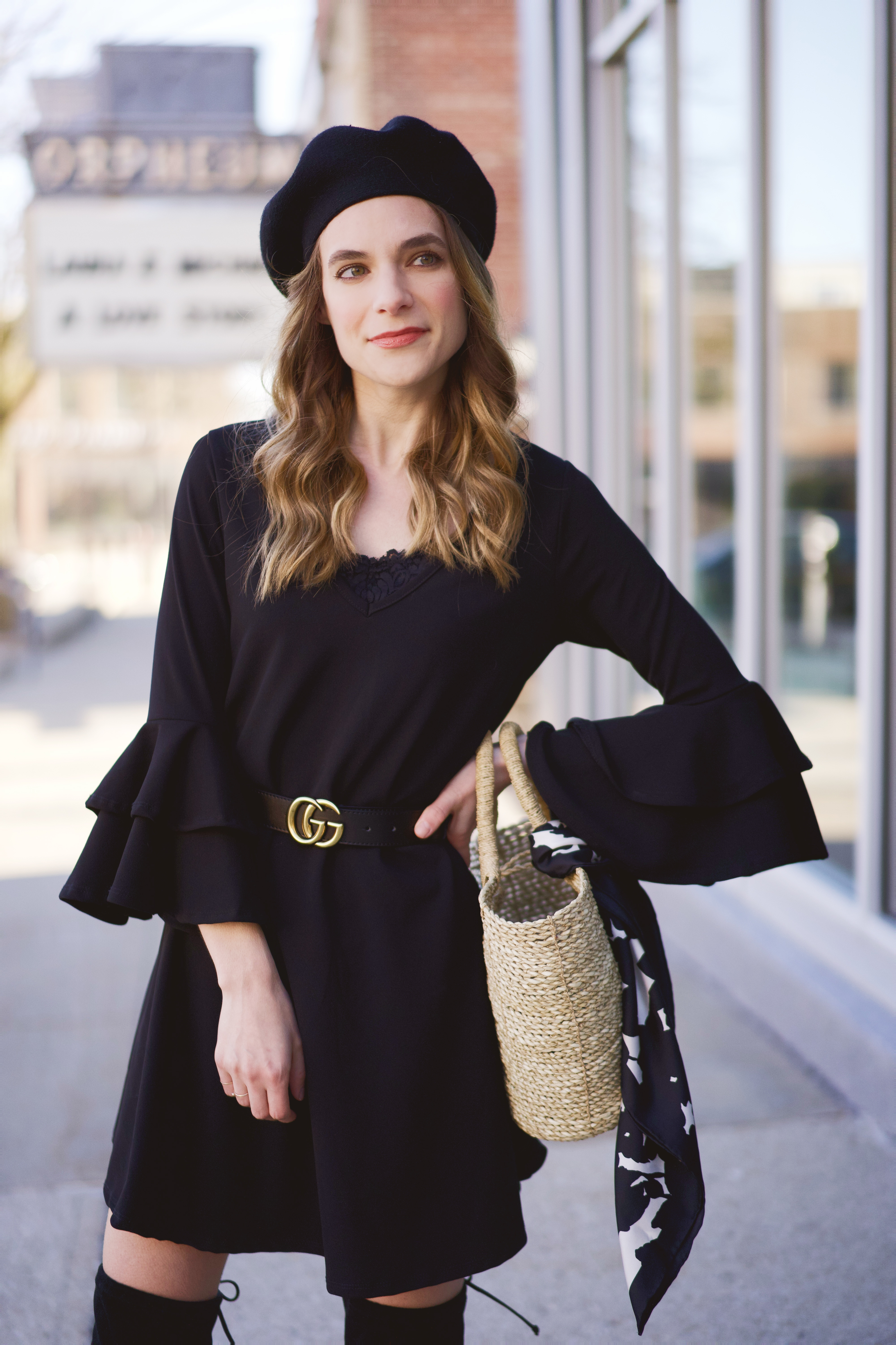 A black beret, dress, and belt