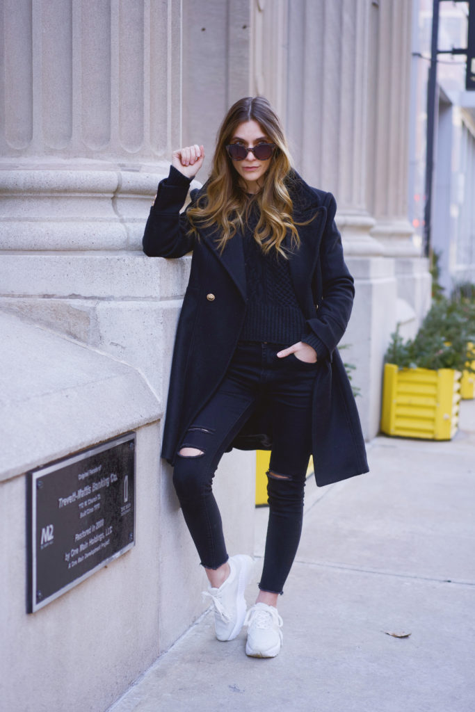 Woman wearing all black with White Sneakers